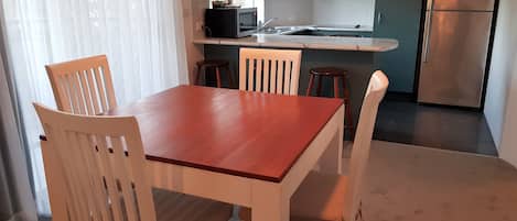 A compact kitchen with a dining area.