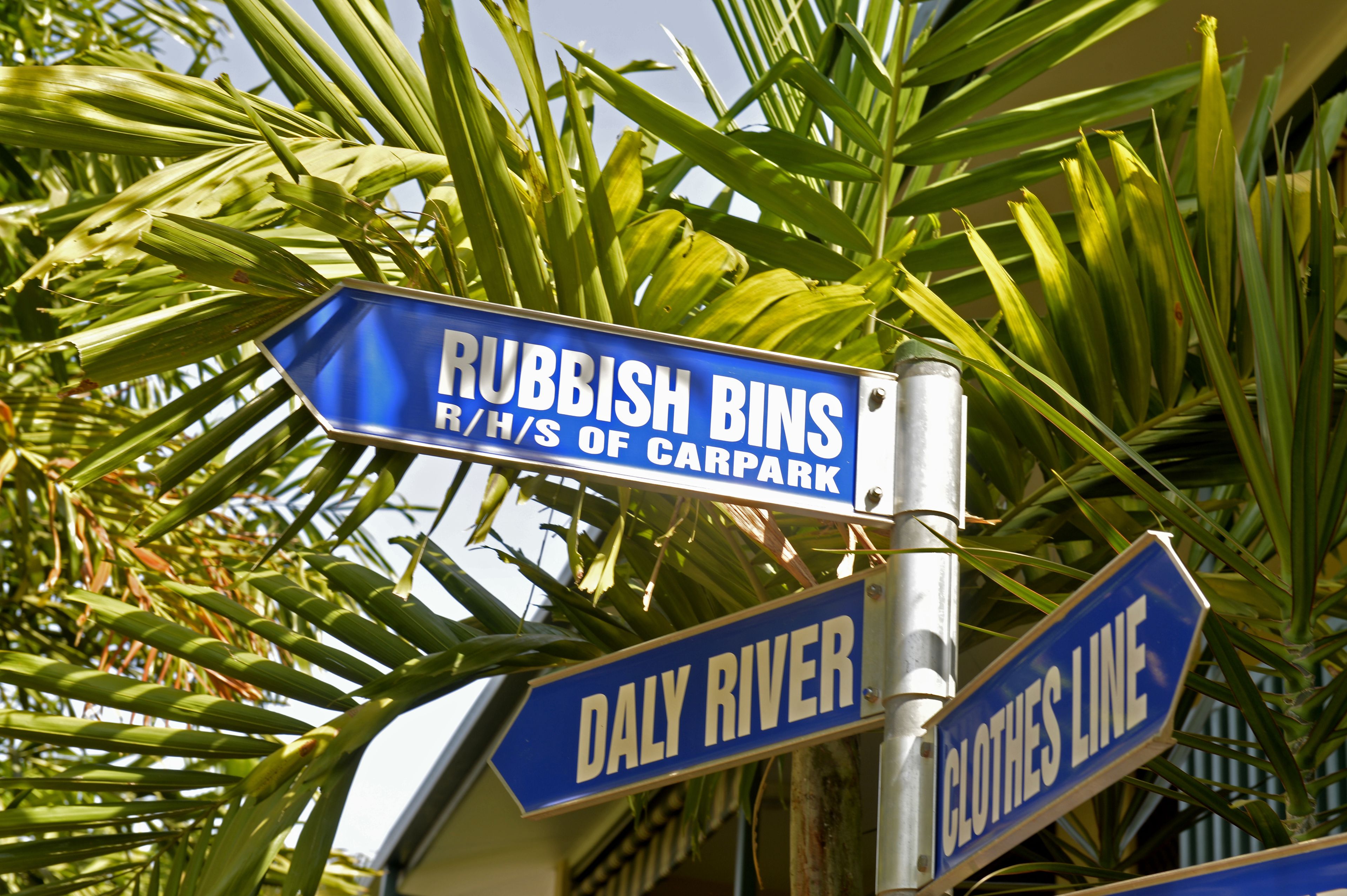 Street signs for 'Rubbish Bins', 'Daly River', and 'Clothes Line'.