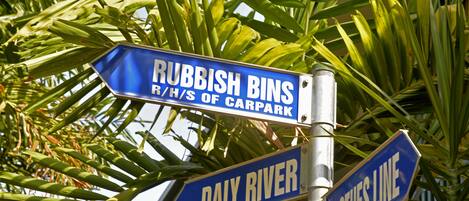 Street signs for 'Rubbish Bins', 'Daly River', and 'Clothes Line'.