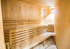 A sauna with wooden benches and slatted seating. - Villa Venezia (Odesa)