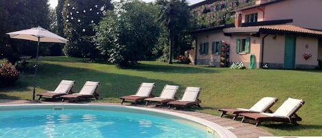 Outdoor pool, open 8:00 AM to 8:00 PM, pool umbrellas, pool loungers
