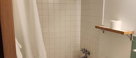 A bathroom with a bathtub, toilet, and sink.