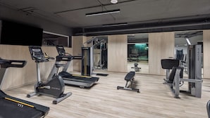 A modern gym with treadmills, a bench press, and a squat rack. -  DOMA Polanco (Mexico City)