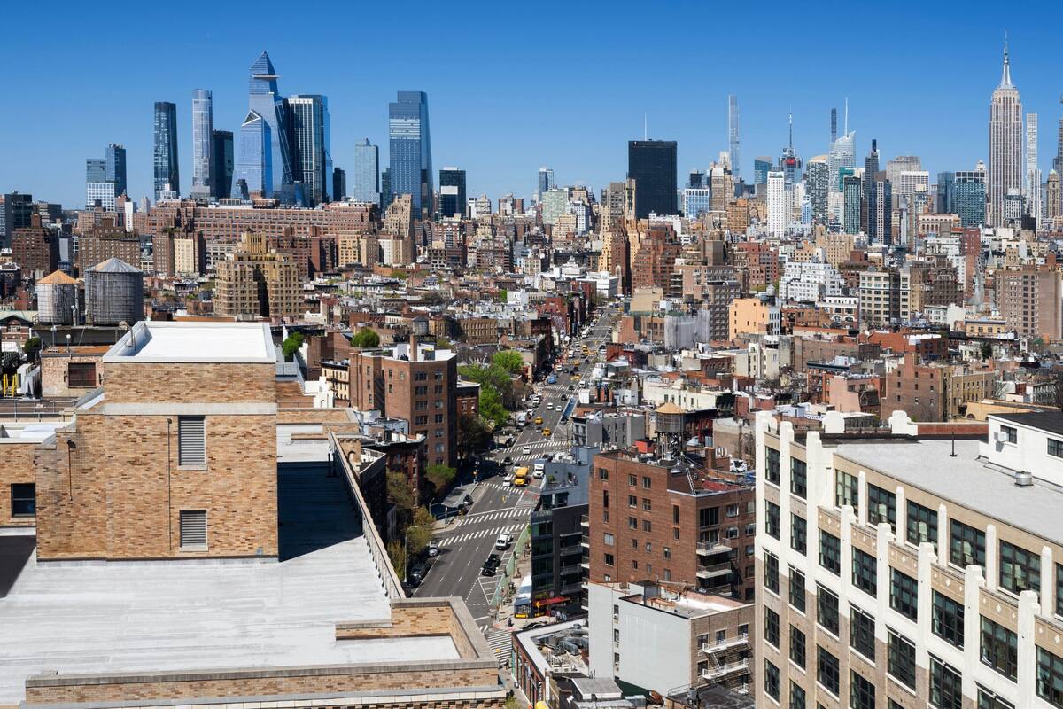 A cityscape with a variety of building types, including modern skyscrapers and older, brick buildings.