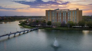 A Hyatt Place hotel with a view of a lake and a bridge. - Hyatt Place Houston/Sugar Land (Sugar Land)