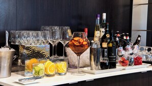 A bar area with various bottles, glasses, and ice buckets. - Courtyard by Marriott Edmonton West (Edmonton)