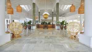 A spacious lobby with a reception desk, wicker chairs, and a marble floor. - Bahia Principe Explore Esmeralda - Hyatt Inclusive Collection - All Inclusive (Punta Cana)