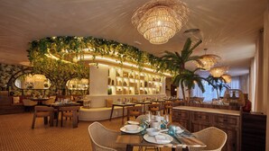 A restaurant with a bar area, wicker furniture, and a ceiling with hanging lights. - Bahia Principe Explore Esmeralda - Hyatt Inclusive Collection - All Inclusive (Punta Cana)