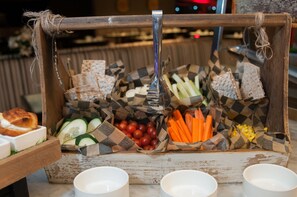 A rustic wooden serving tray with various food items like bread, vegetables, and tomatoes, accompanied by white bowls. - Enjoy Antofagasta (Antofagasta)