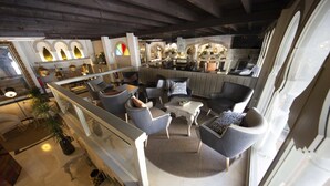A spacious living area with modern furniture, a glass railing, and a view of the kitchen. - Hotel Casablanca (Almunecar)