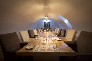 Formal dining area with a long table and comfortable seating, perfect for a special meal.
