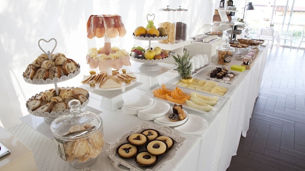 A buffet with various food items including pastries, fruits, and cookies. - Andris Hotel (Ercolano)