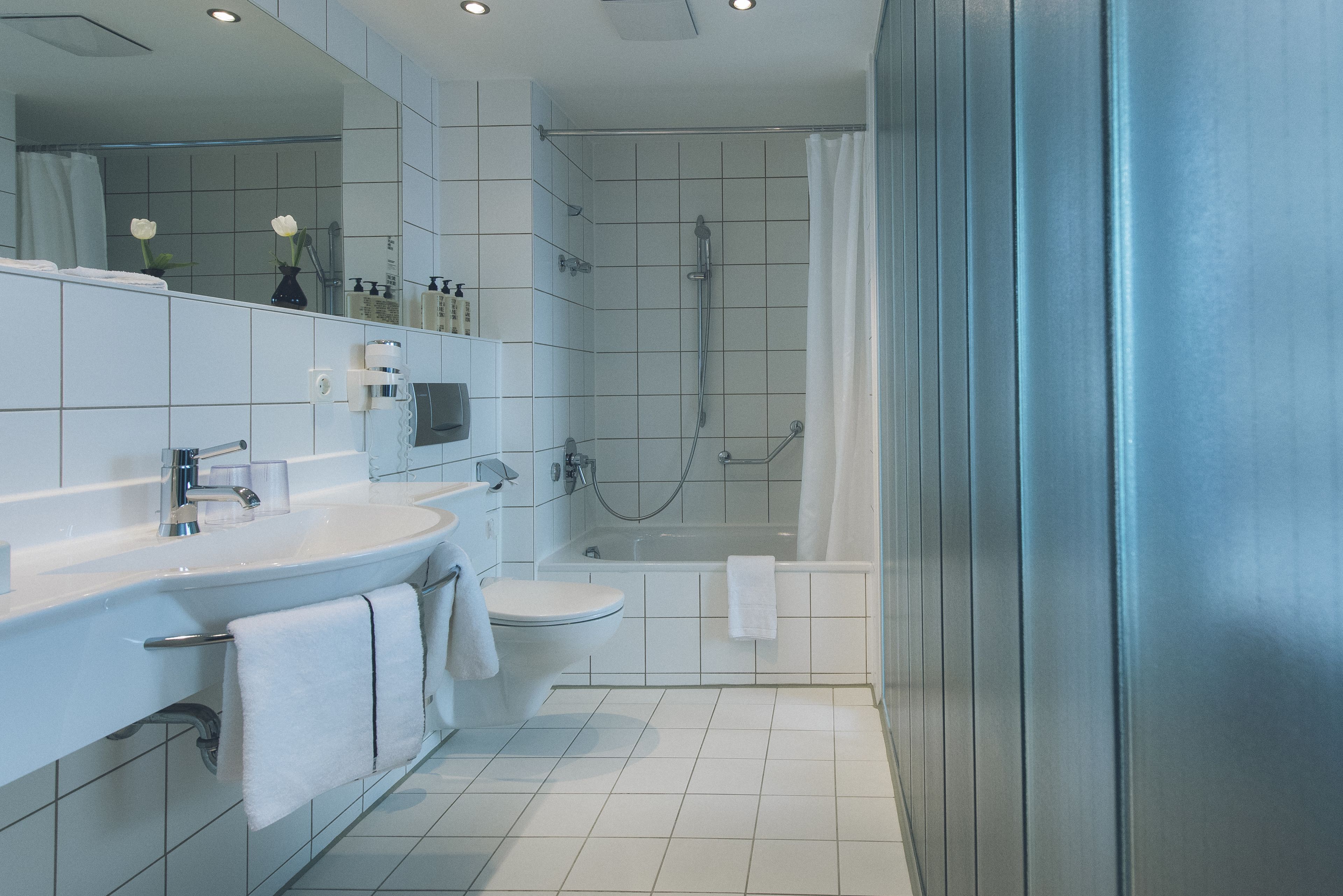 designer toiletries, hair dryer, towels