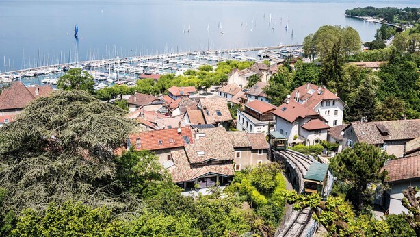 A coastal town with a marina, traditional houses, and a bridge.