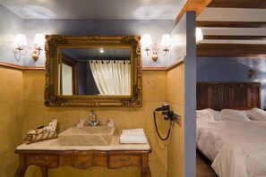 A bathroom with a sink, mirror, and shower curtain.