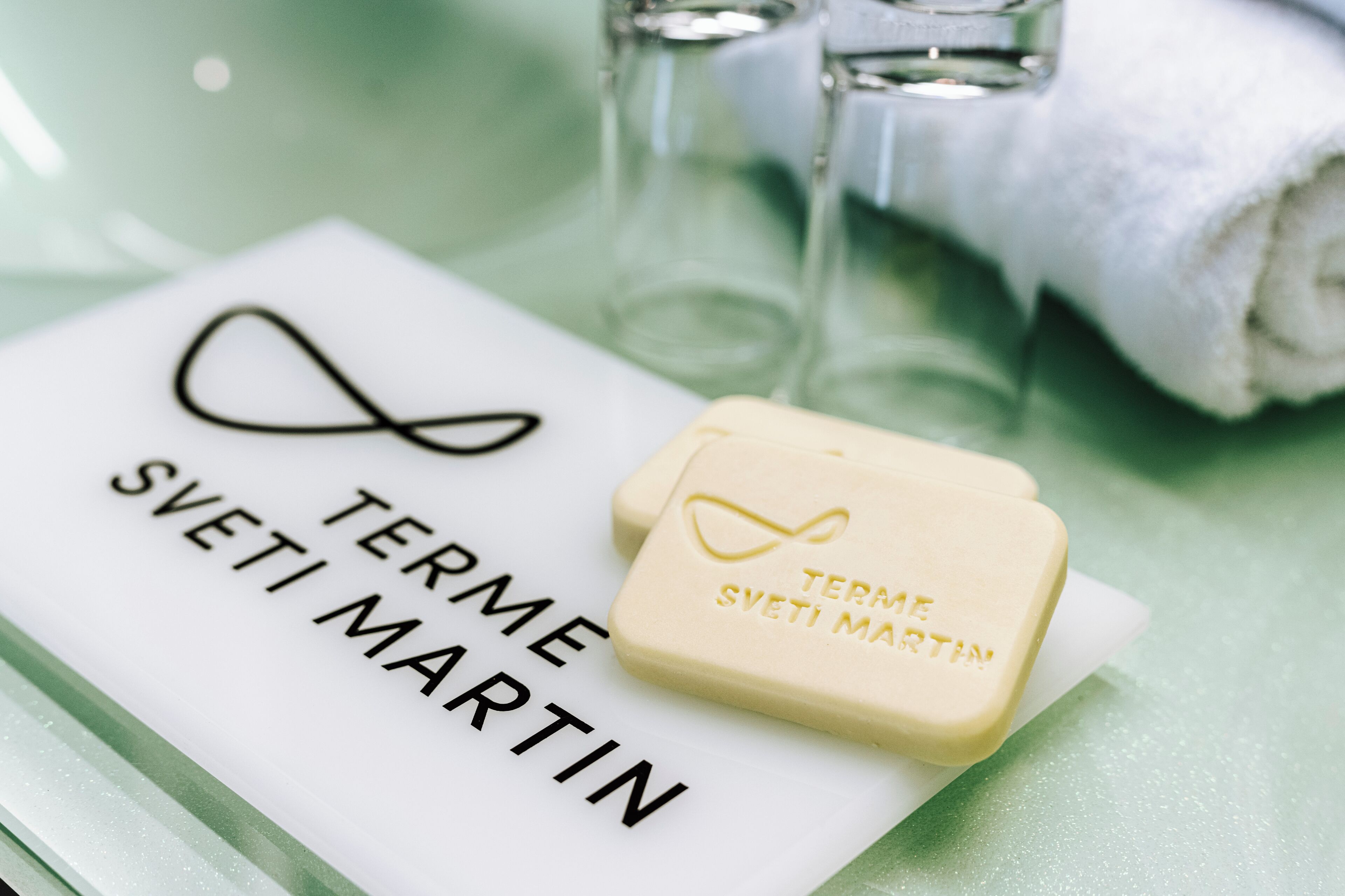 A white card with the text "TERME SVETI MARTIN" and a bar of soap with the same text.