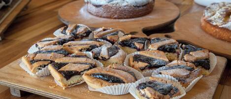 A wooden table with various pastries and desserts.