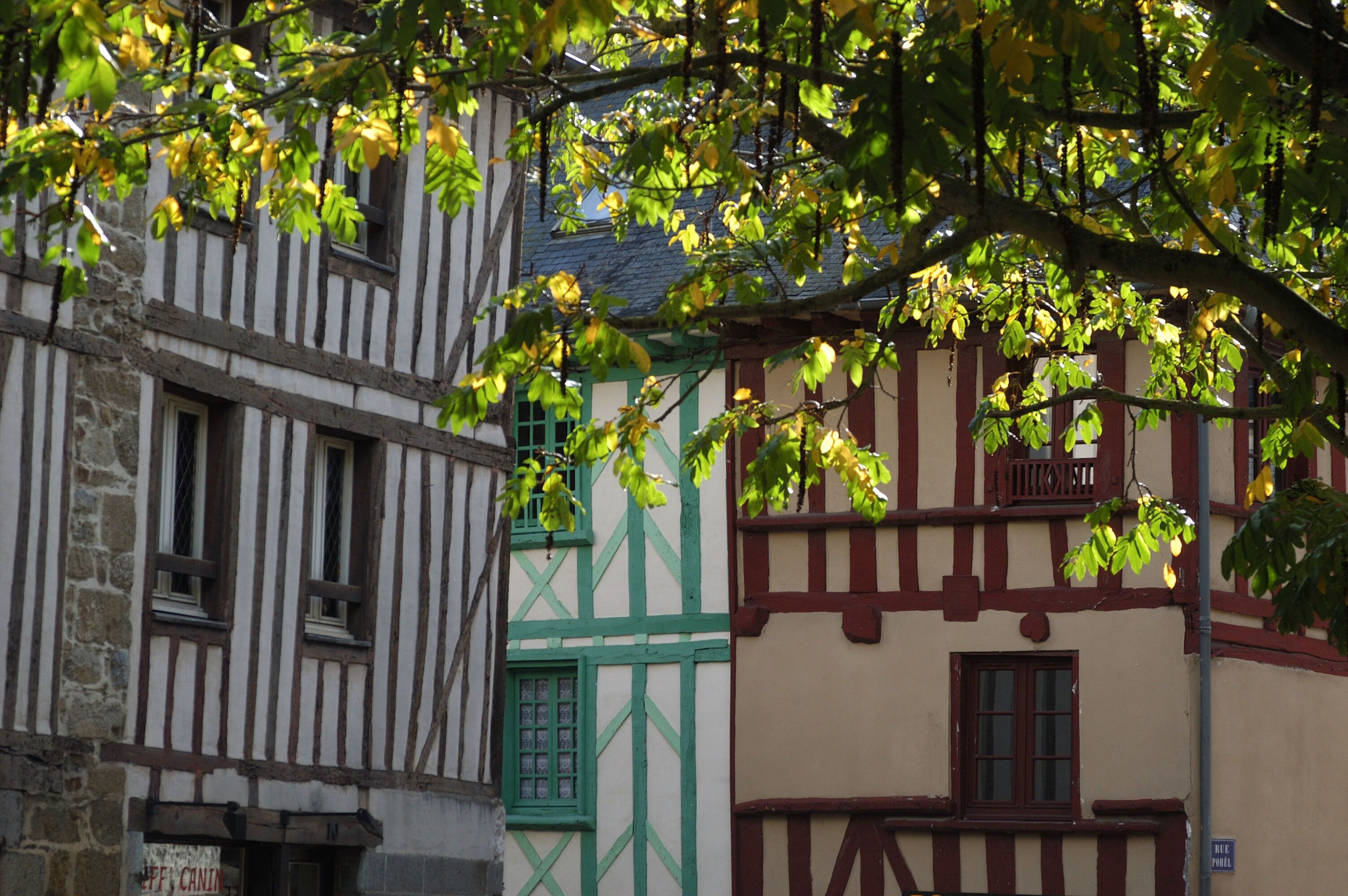 A traditional half-timbered building with visible window frames and a green door.