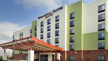 A SpringHill Suites Marriott hotel with a modern design, featuring a covered entrance and multiple floors.