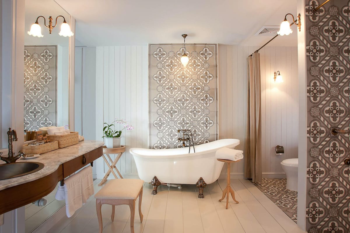 devasom signature suite with sea view | bathroom | separate bathtub and shower, rainfall showerhead, designer toiletries