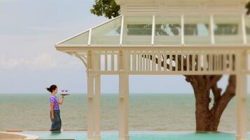 Relax in a serene seaside setting with a gazebo and ocean views.
