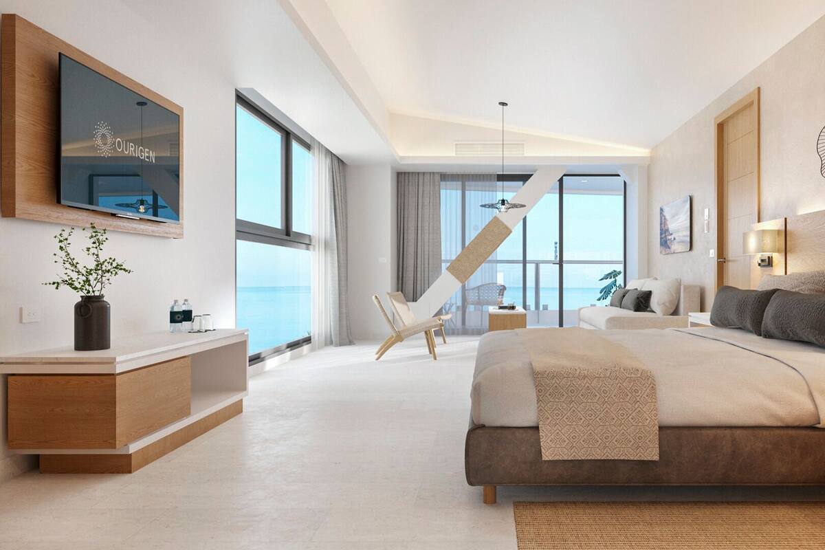 A modern bedroom with a large bed, a TV mounted on the wall, and a balcony with a view.