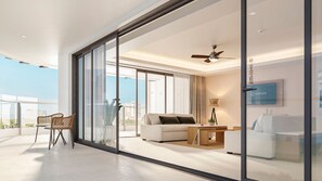 Sunset Suite Ocean Front | Living area | 55-inch flat-screen TV with cable channels