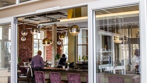 A restaurant with a glass door entrance, a bar area with purple chairs, and a visible sign reading "WODKA RESTAURANT & BAR". - The Waterfront hotel & spa by Misty blue hotels (Durban)