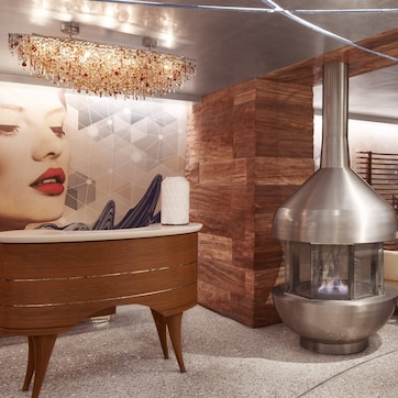 A modern interior with a wood-paneled wall, a large metal stove, a white sofa, and a decorative wall piece.
