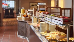 A buffet setup with various fruits, cheeses, and dishes. - Familienparadies Sporthotel Achensee - All Inclusive (Achenkirch)