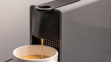 A coffee machine dispensing coffee into a cup.