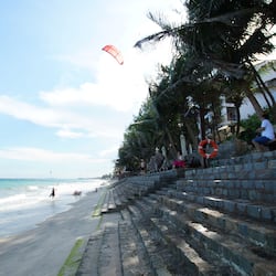 On the beach, sun-loungers, beach umbrellas, waterskiing
