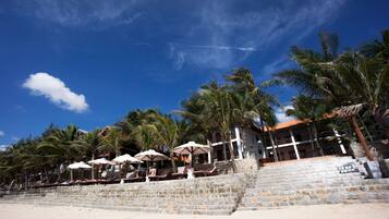 On the beach, sun loungers, beach umbrellas, water skiing