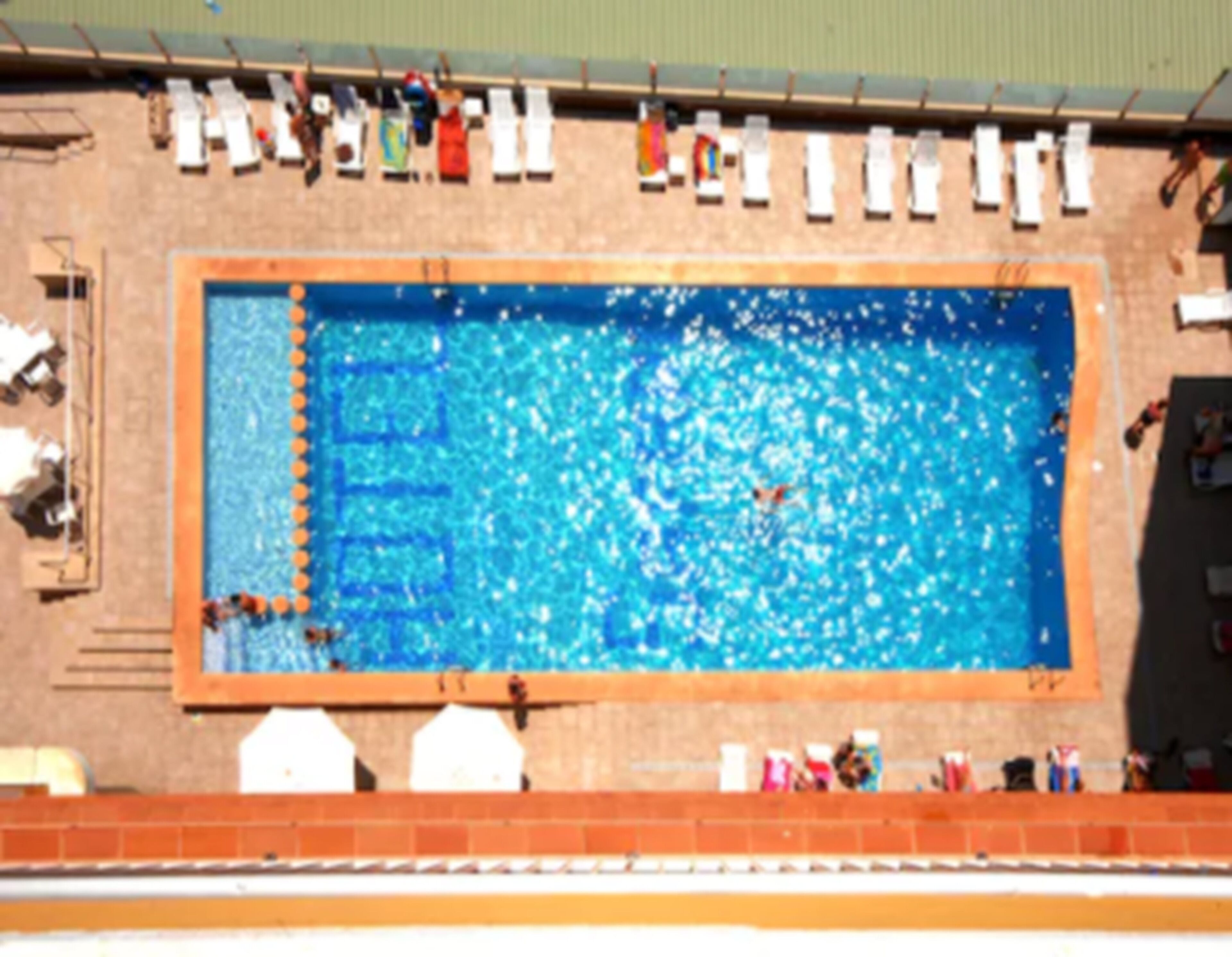 Een seizoensgebonden buitenzwembad, parasols voor strand/zwembad