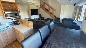 A compact living space with a kitchen, dining area, and seating.