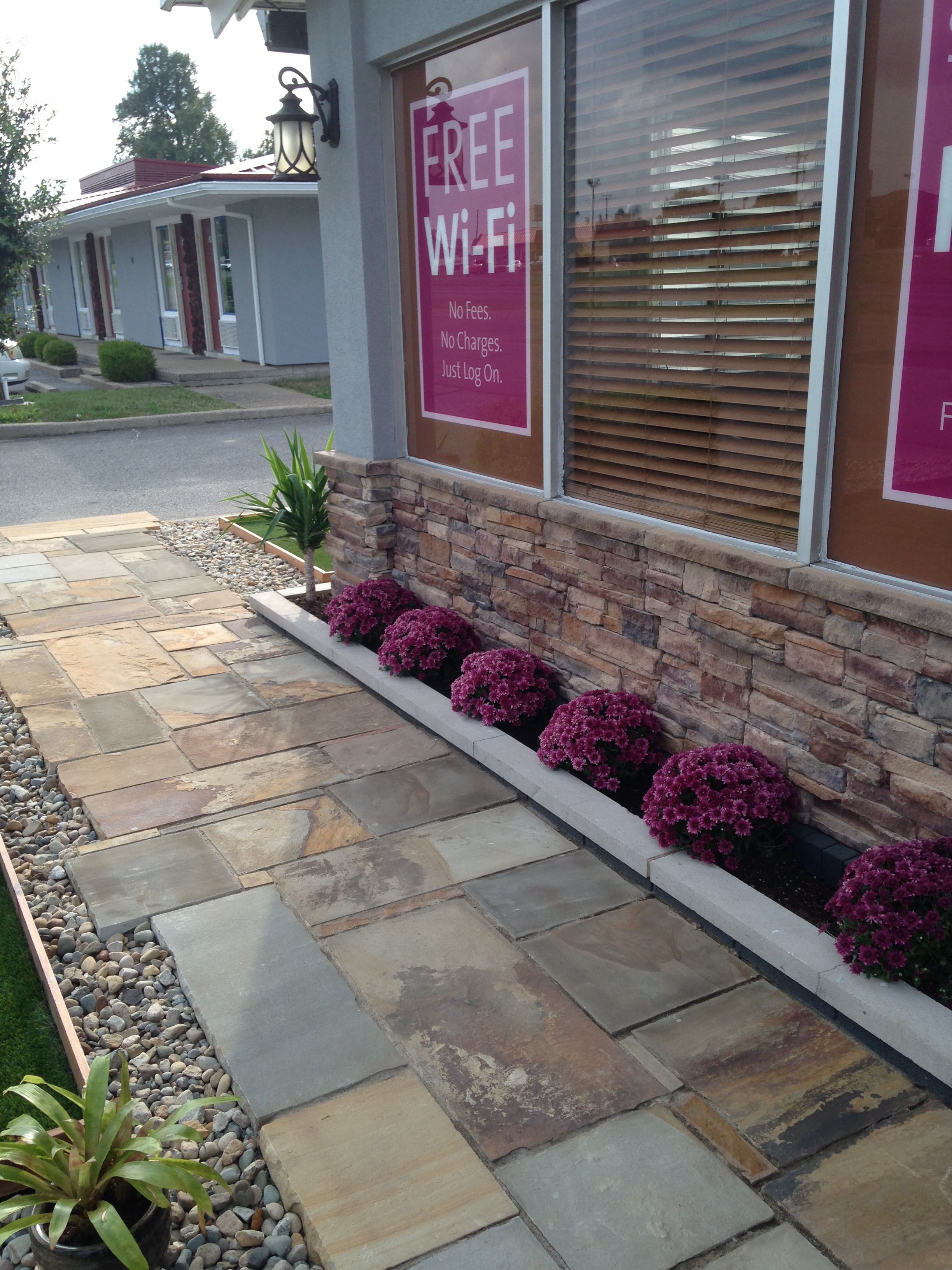 A building with a stone facade and a sign offering free Wi-Fi.