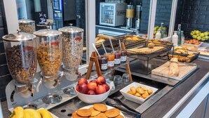 A breakfast buffet with various food items and condiments. - OUT Hotel In Nantes-Carquefou (Carquefou)