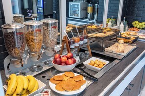 A breakfast buffet with various food items and condiments.