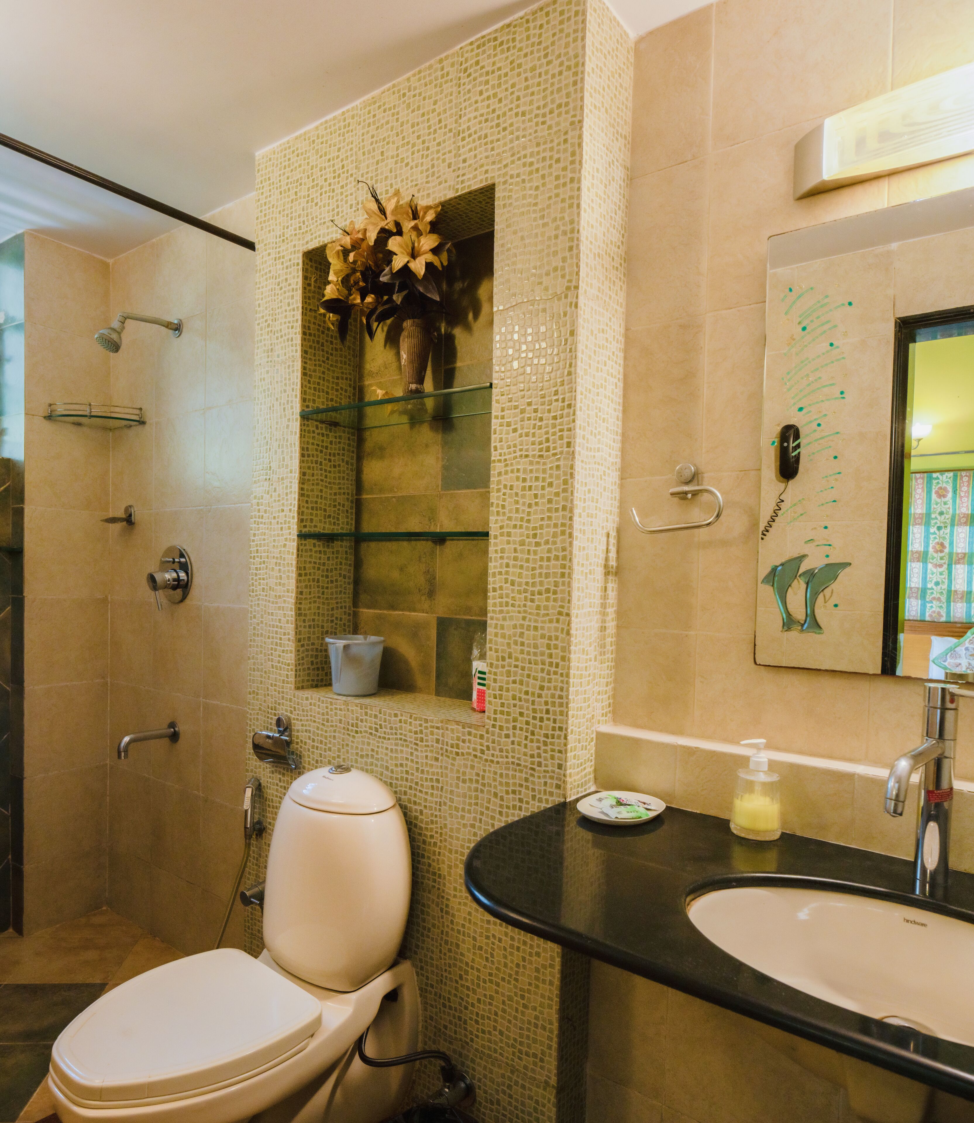 A modern bathroom with a toilet, bidet, and shower area.