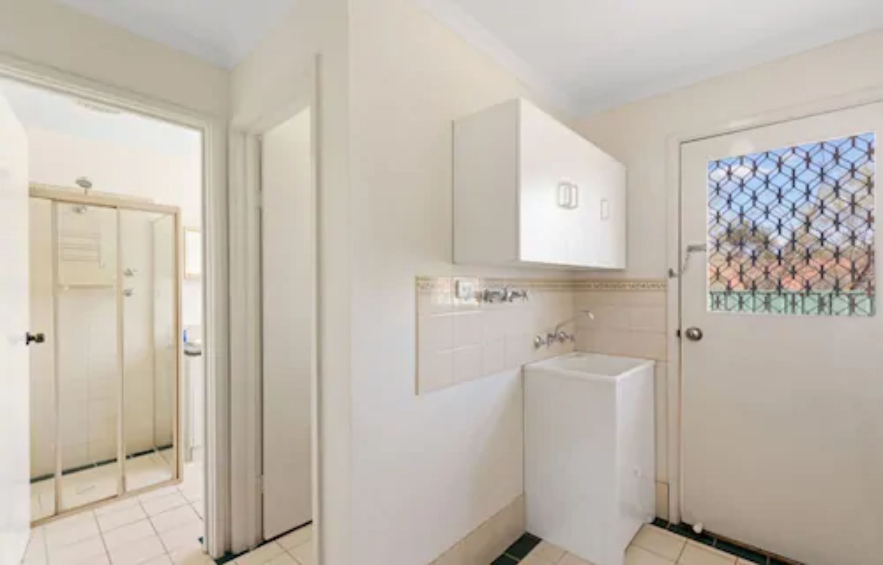 A bathroom with a sink, mirror, and cabinet.