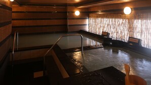 A hot tub area with a wooden floor, metal railings, and a tiled wall. - Kobe PortTower Hotel (Kobe)