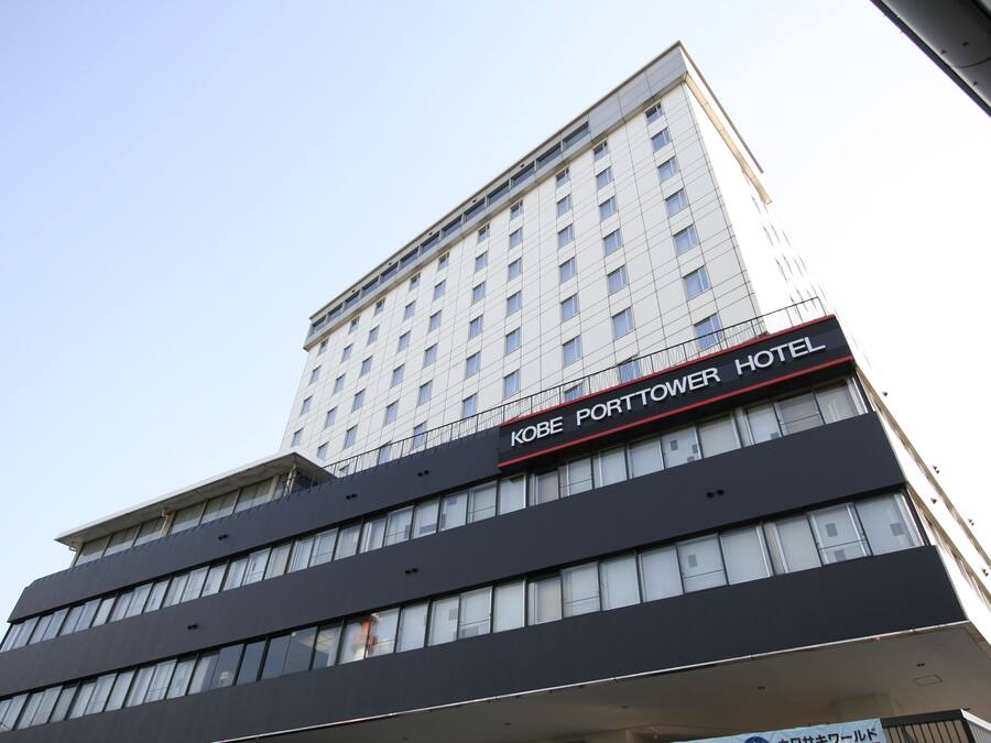 Um edifício de vários andares com uma placa que diz 'Kobe Porttower Hotel'.