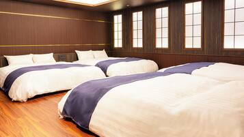 Habitación de hotel con dos camas, paneles de madera y ventanas amplias.