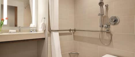 A modern bathroom with a shower, a toilet, and a sink.