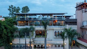 A multi-story hotel with a traditional architectural style, featuring balconies and a courtyard. - Panna Vilas - A Lake Facing Boutique Hotel (Udaipur)