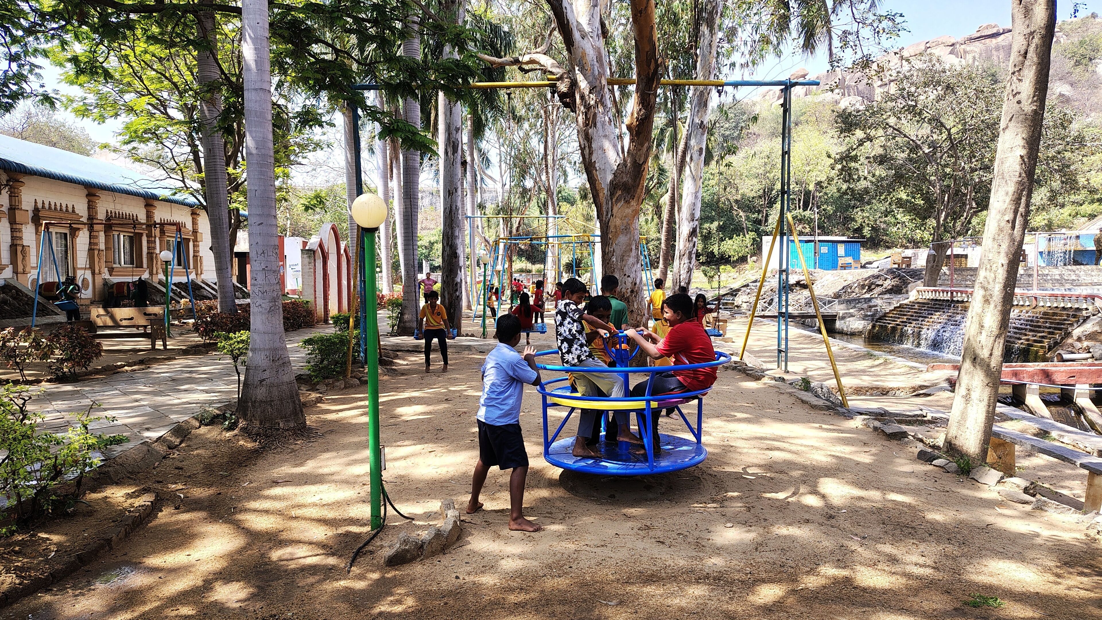 A playground with swings and a merry-go-round.