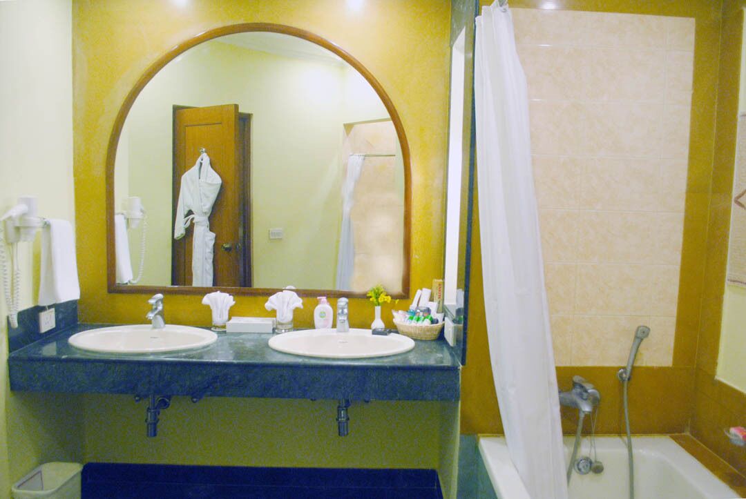deluxe suite with ocean view | bathroom | slippers, towels