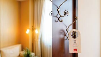A hotel room with a wooden door, a metal handle, and a keycard with a hotel logo.