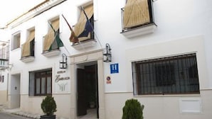 A hotel with a sign reading "Hotel de la Consolacion" and a blue handicap accessibility sign. - Hotel Esmeralda (Osuna)