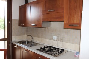 Apartment, 1 Bedroom, Terrace | Private kitchen | Fridge, stovetop, coffee/tea maker, cookware/dishes/utensils - Il Casaletto dei Ludi (Fiumicino)